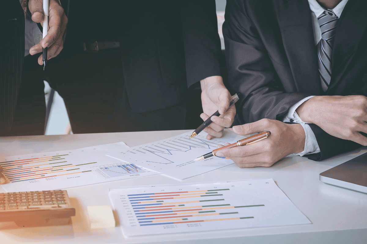 Two executives reviewing financial charts during due diligence, assessing investment readiness and company valuation
