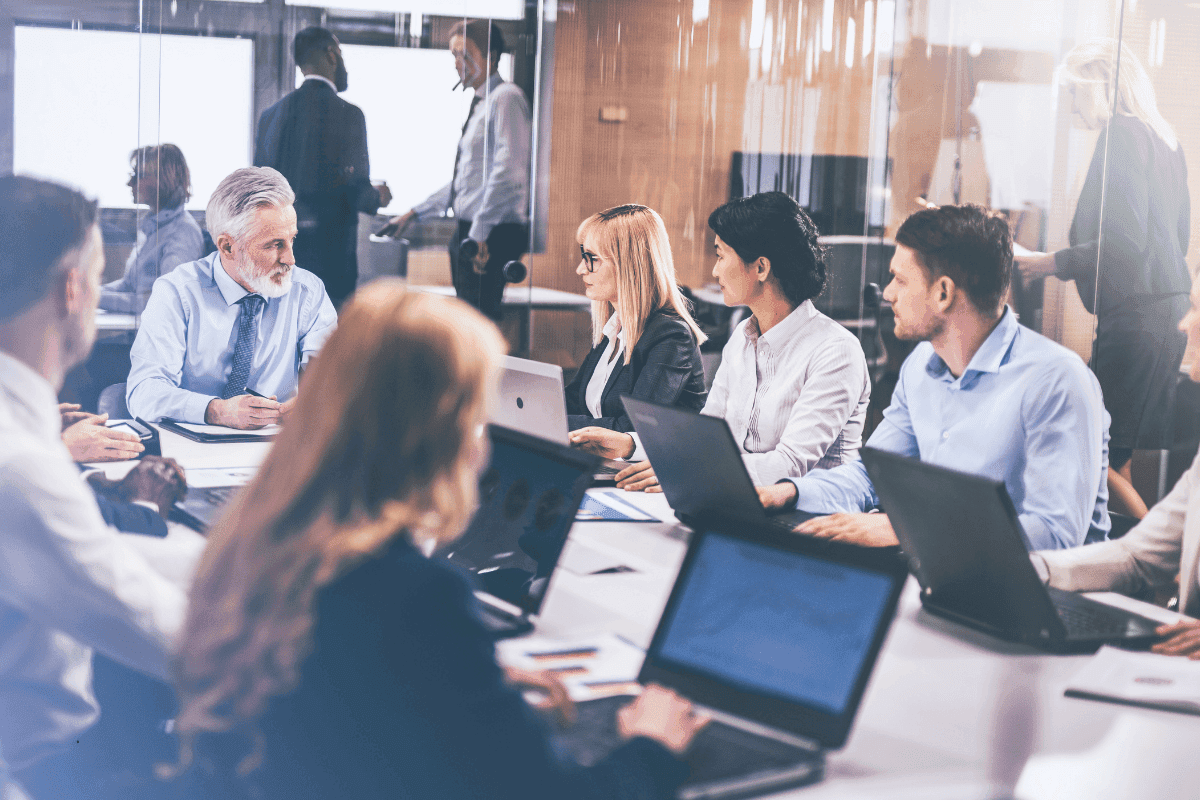 Corporate team in an office discussing execution architecture and governance frameworks during a strategy meeting.